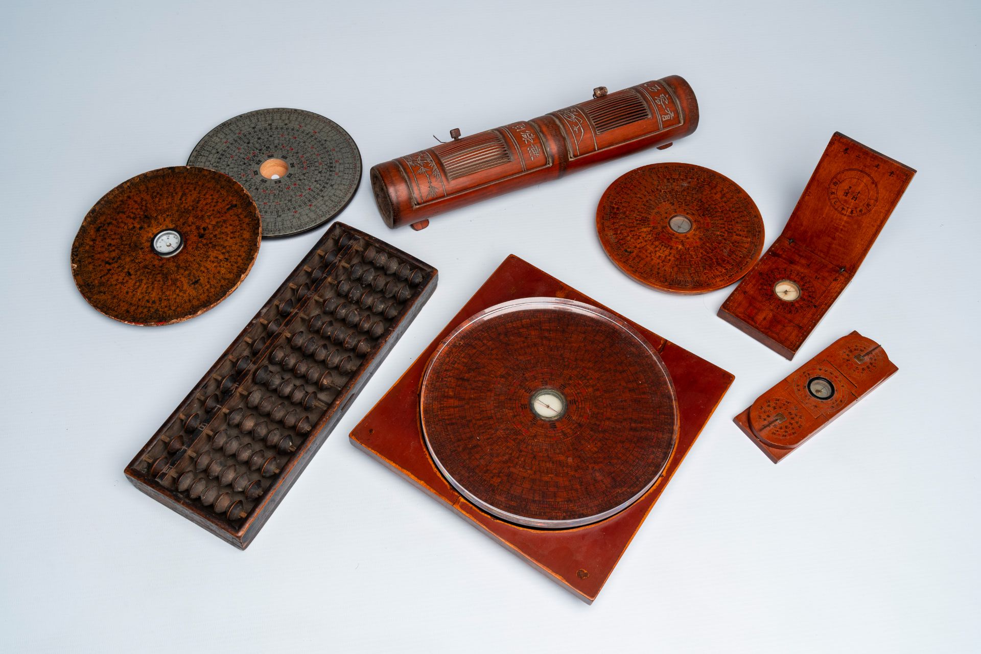 Six various Chinese Feng Shui compasses, a bamboo cricket box and an abacus, 19th/20th C.