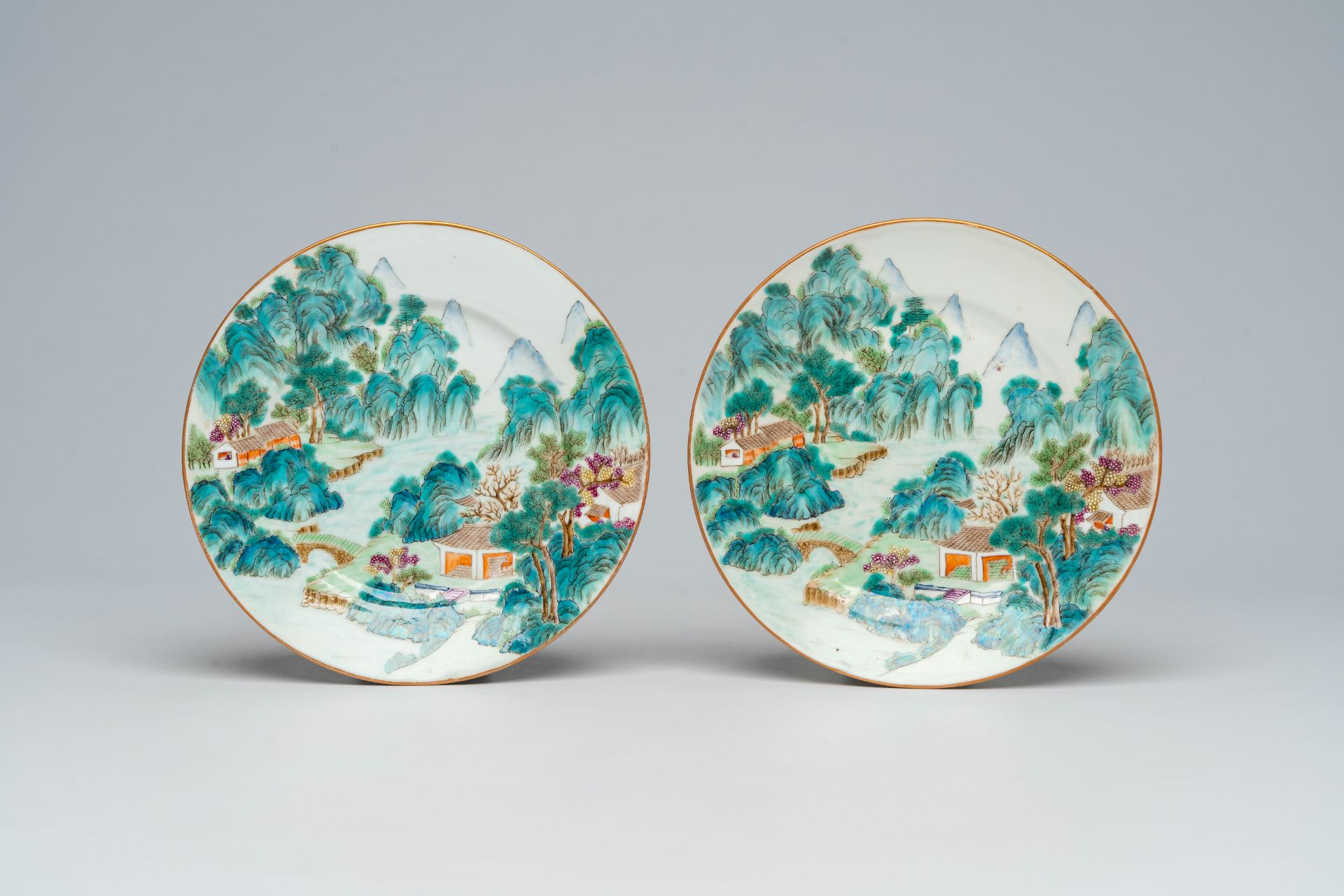 A pair of Chinese famille rose plates with a river landscape, Jiaqing mark, 19th/20th C.