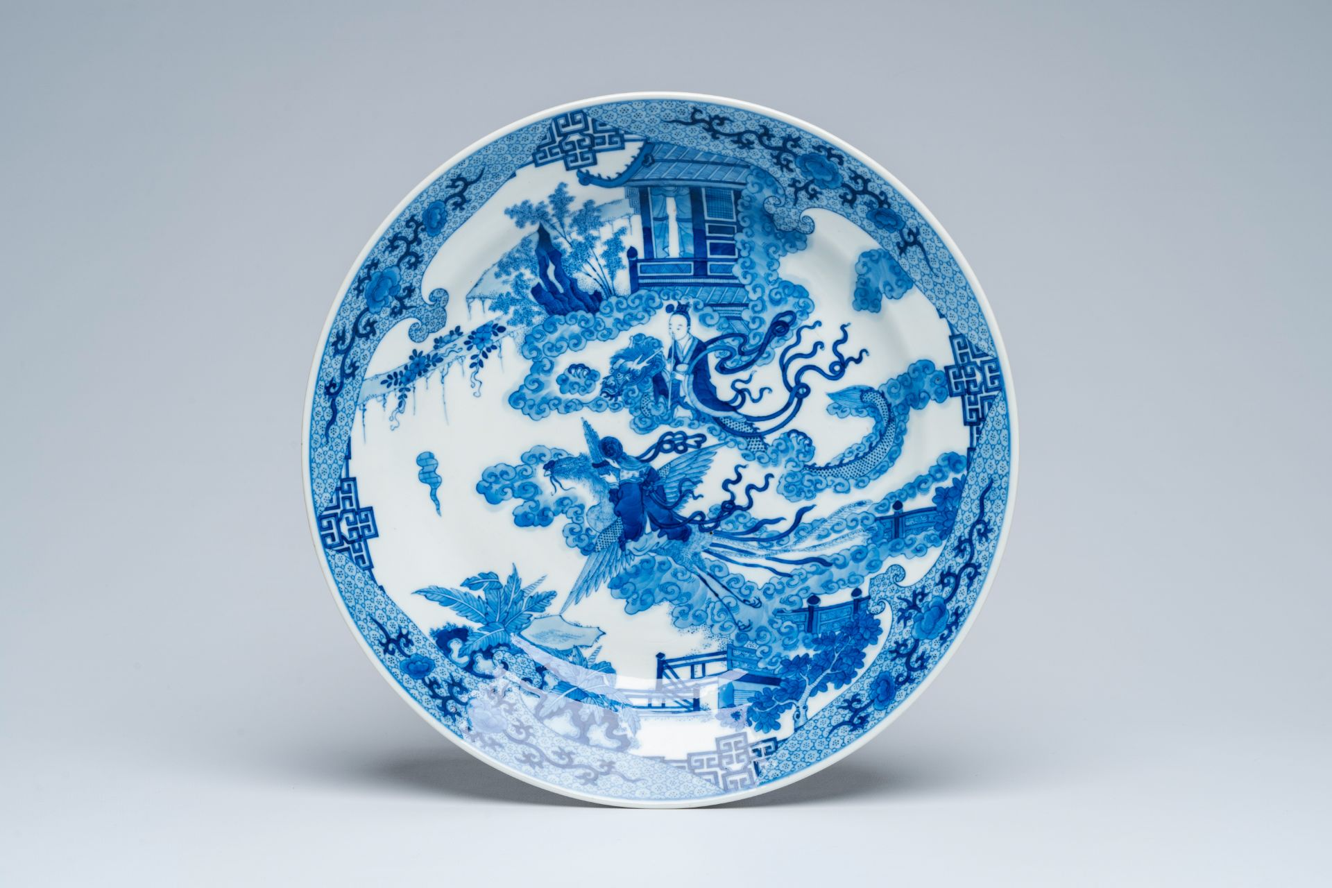 A Chinese blue and white 'dragon and phoenix riders' charger, 19th C.
