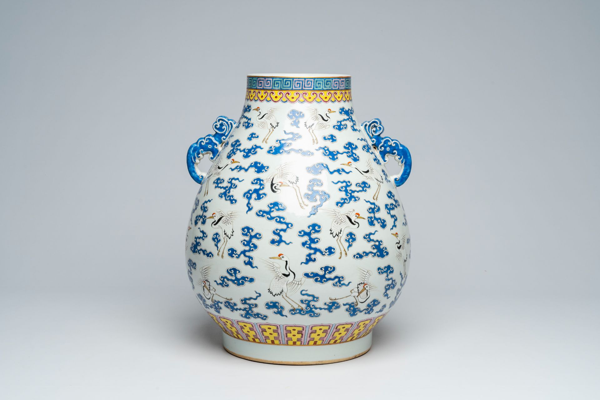 A Chinese famille rose 'hu' vase with cranes between clouds, Qianlong mark, 20th C. - Image 3 of 6