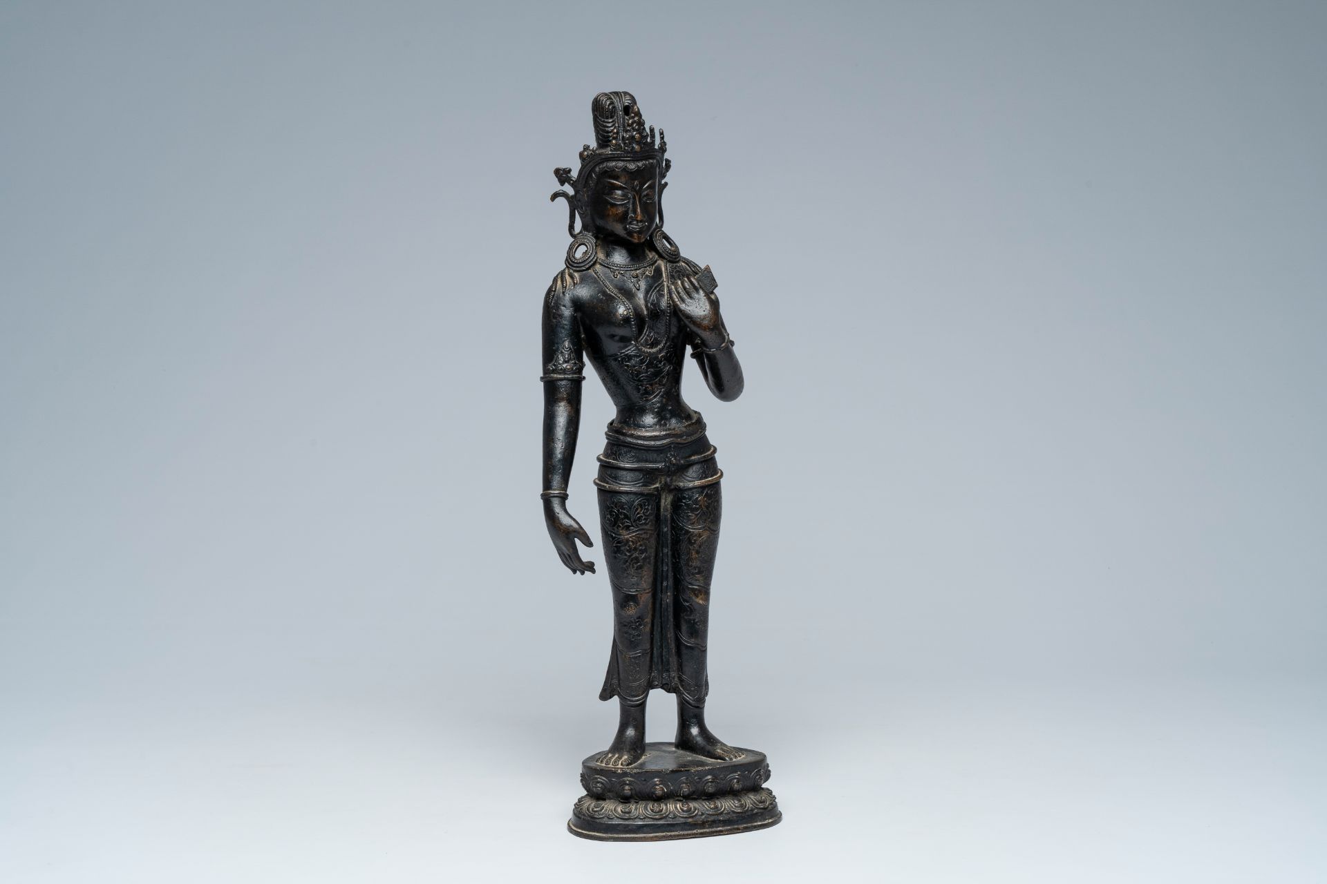 A large Nepalese patinated bronze figure of a standing Tara on a lotus throne, 19th/20th C.