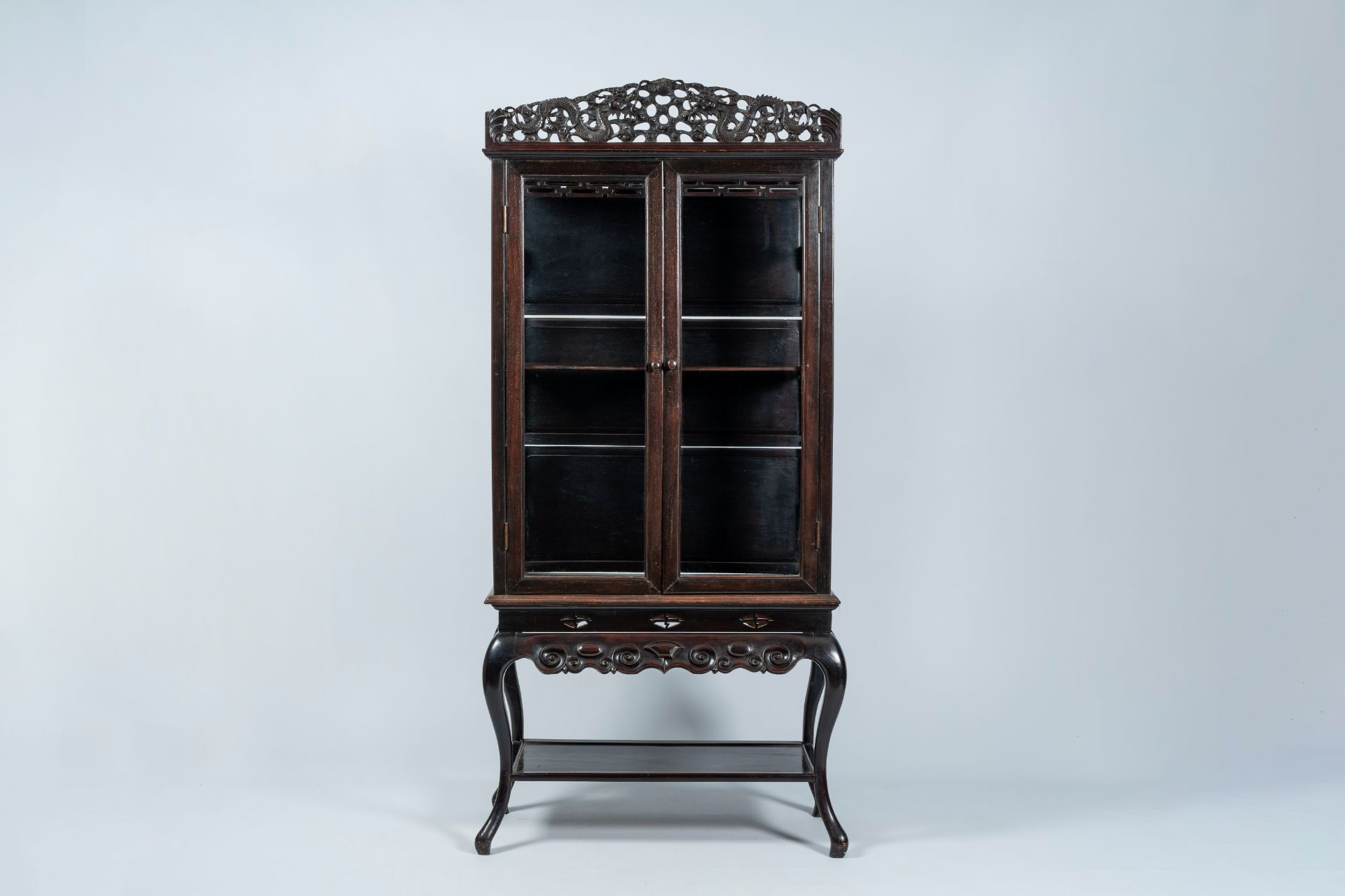 A Japanese wood two-door 'dragons chasing the pearl' display cabinet, first half 20th C.