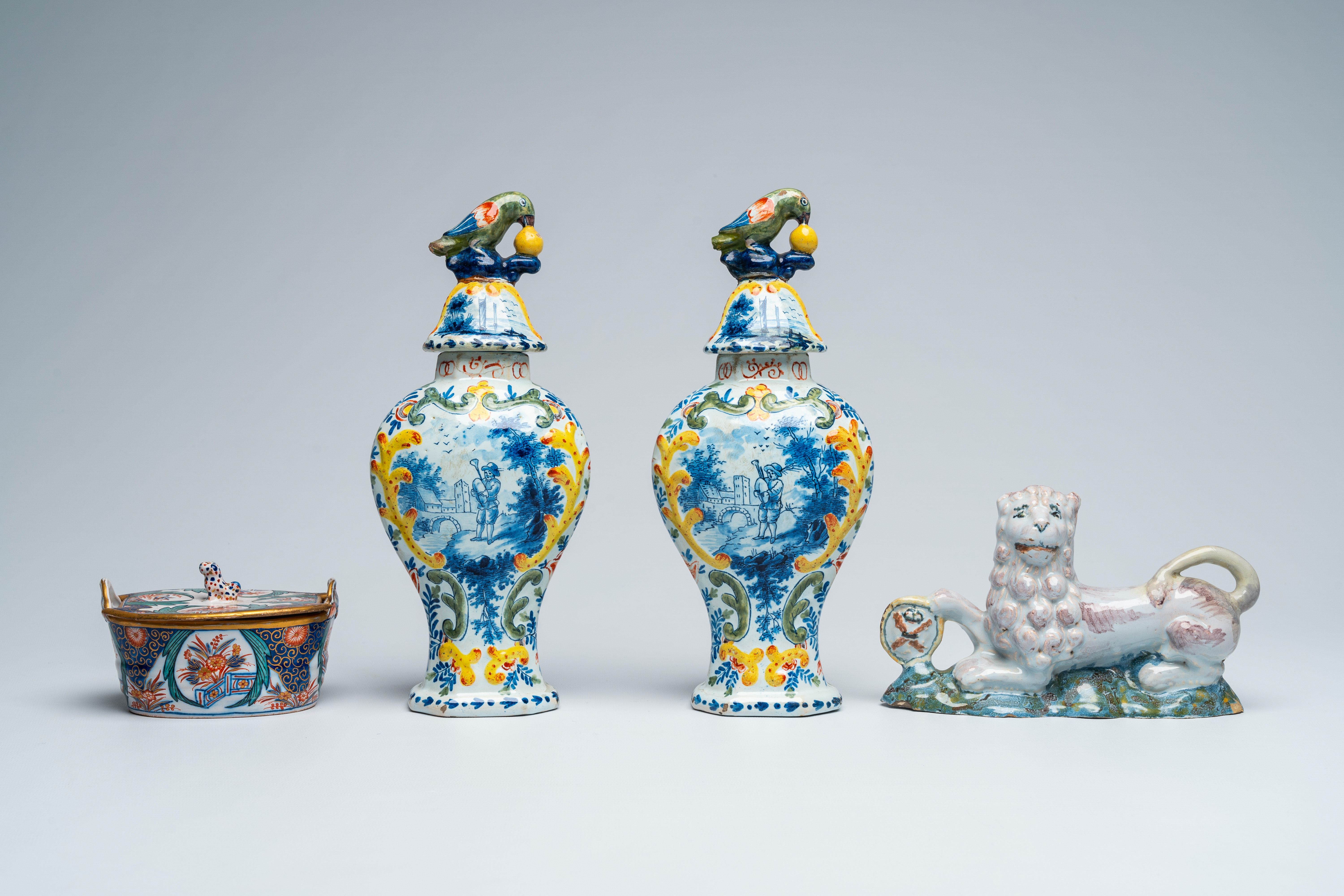 A pair of polychrome Delft vases and covers, a butter tub and a reclining lion, 18th and 19th C. - Image 2 of 7