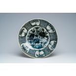 A large Chinese blue and white Swatow charger with a bird among blossoming branches, Ming