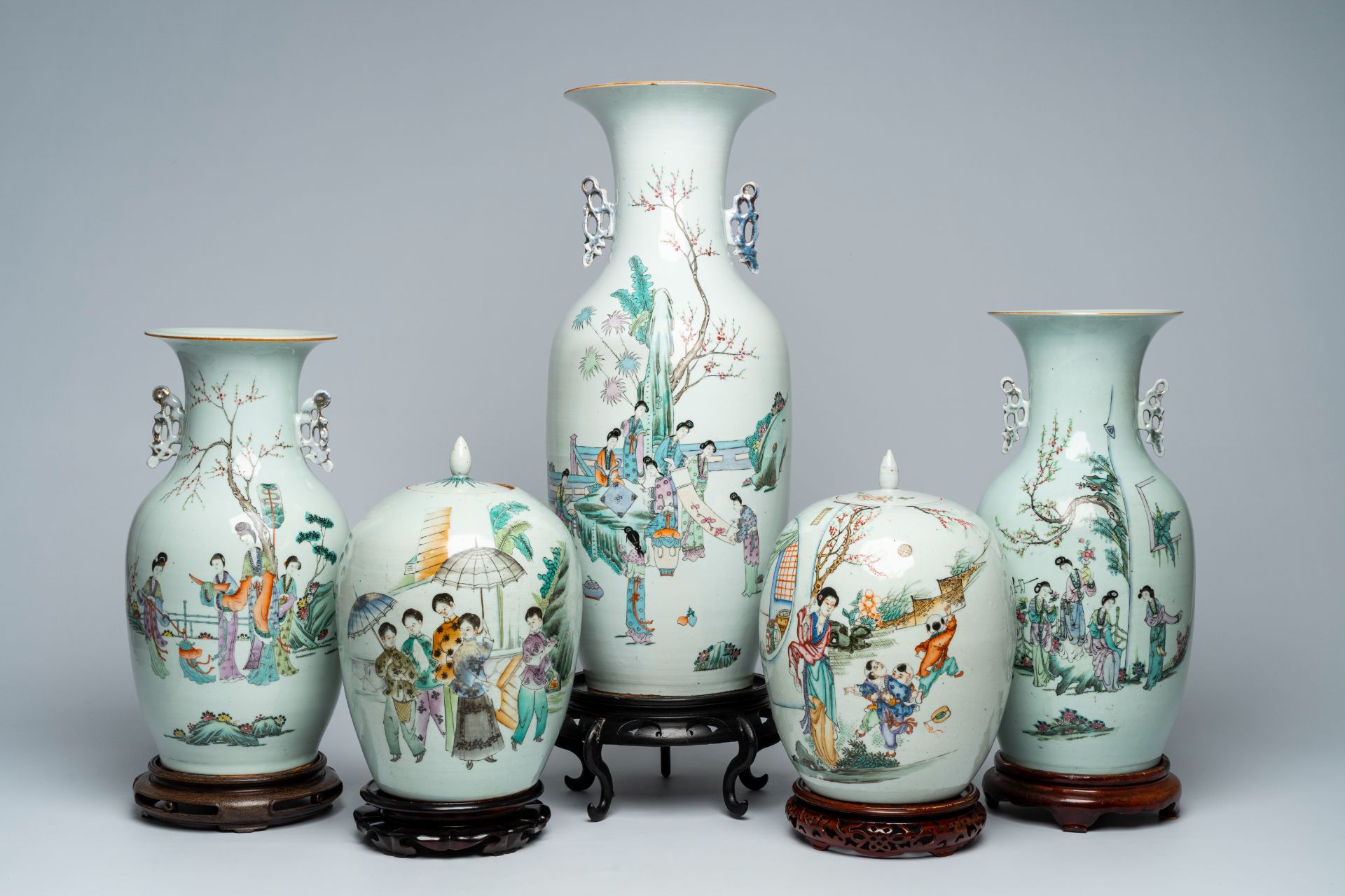 Three Chinese famille rose and qianjiang cai vases with ladies in a garden and two jars and covers,