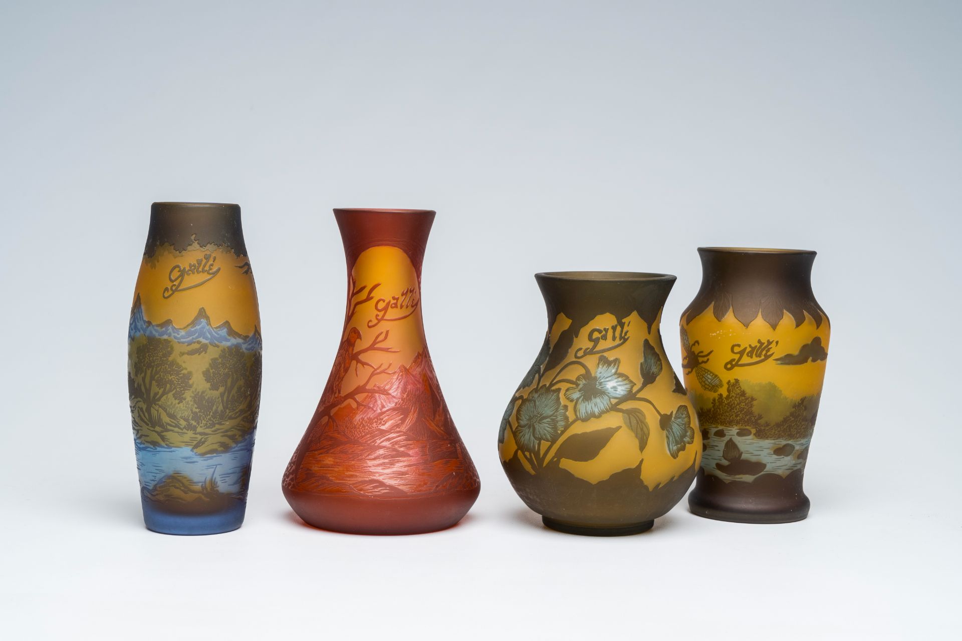 Emile GallÃ© (1846-1904): Four cameo glass Art Nouveau vases with landscapes and floral design, 20th