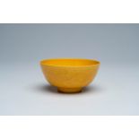 A Chinese monochrome yellow bowl with incised design of dragons and phoenixes, Jiaqing mark, 19th/20