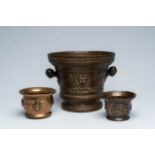 Three various bronze mortars with relief design, 17th C. and later