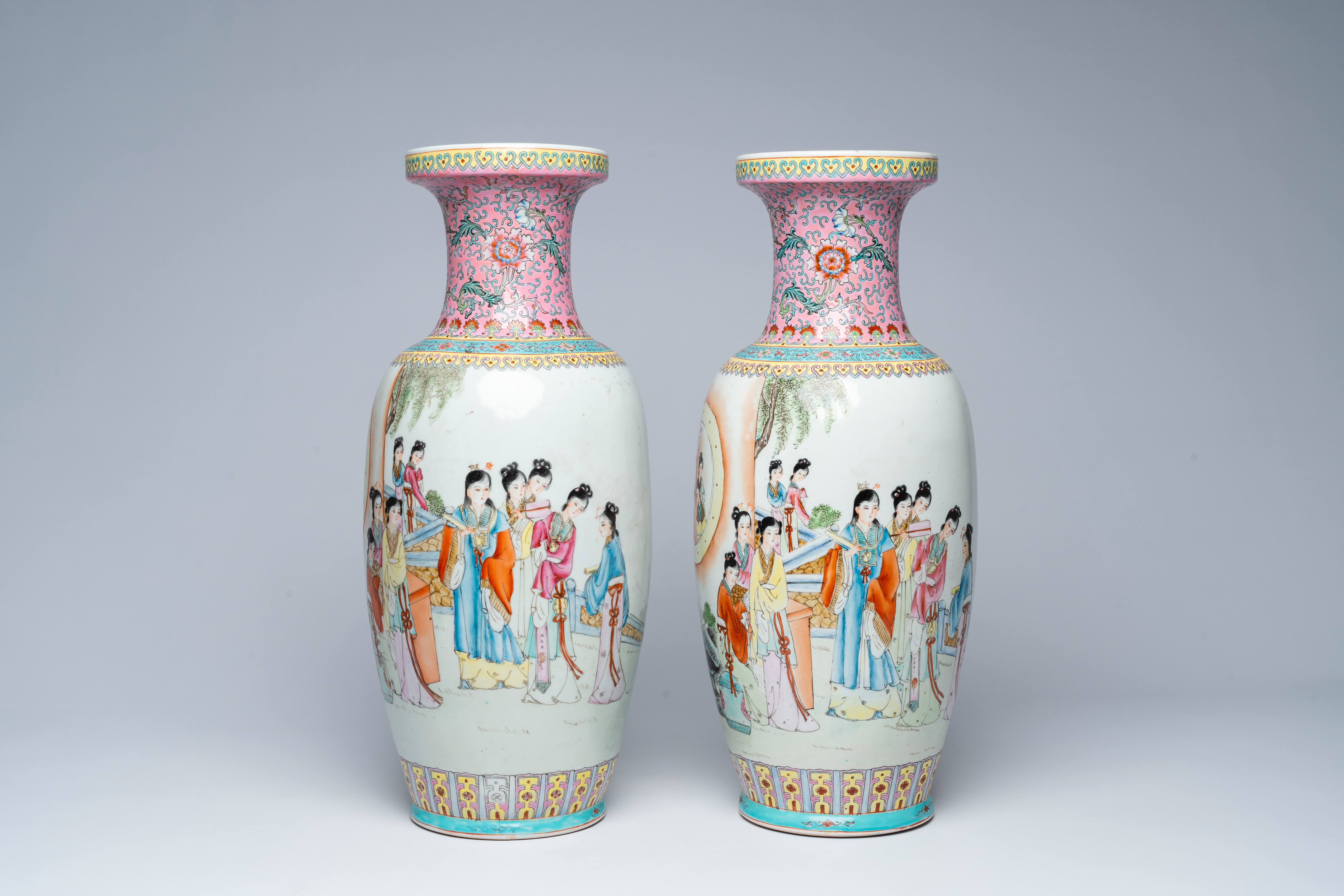 A pair of Chinese famille rose vases with court ladies in a palace garden, 20th C.