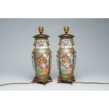 A pair of Chinese Canton famille rose vases with palace scenes mounted as lamps, 19th C.