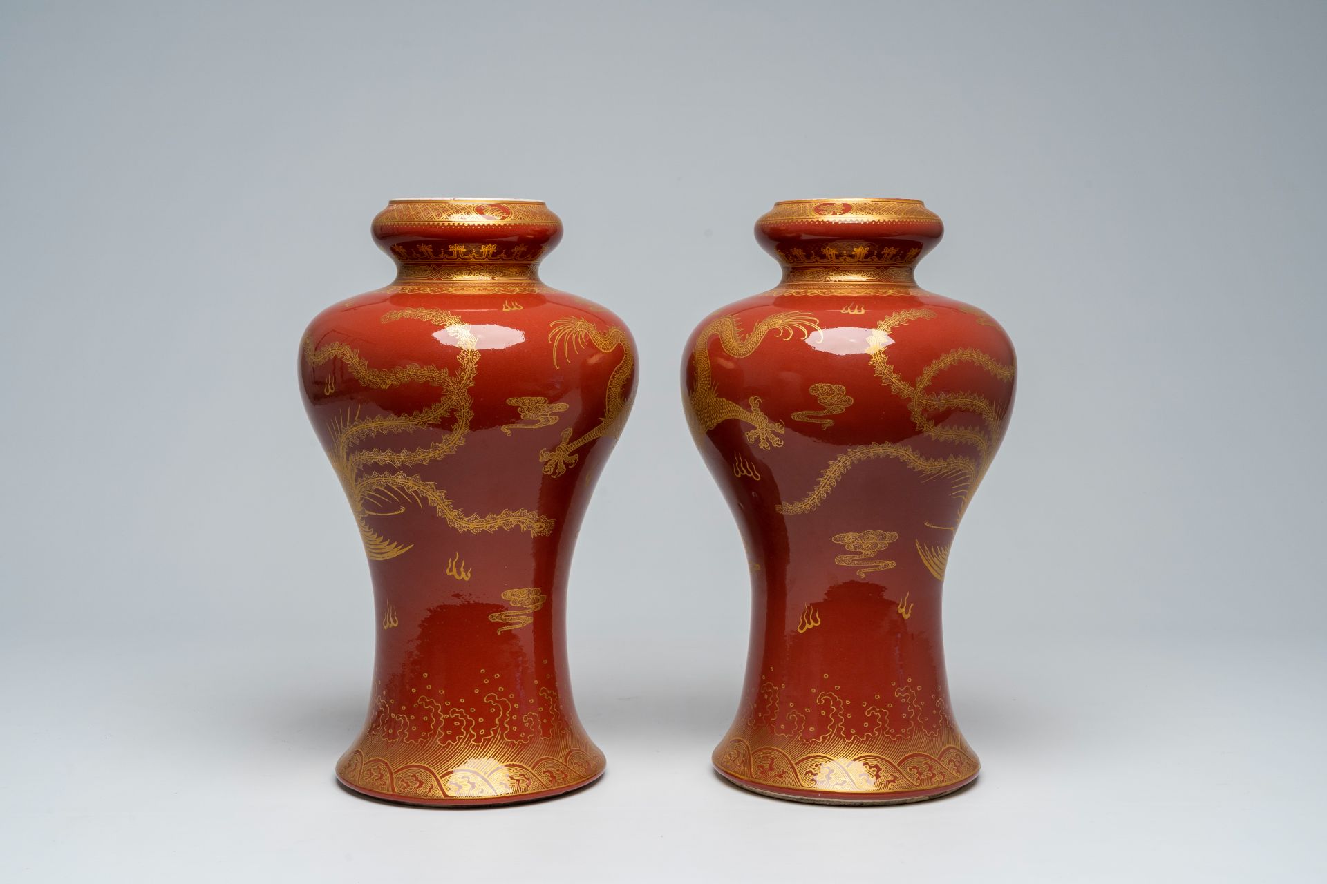 A pair of Chinese monochrome red vases with a gilt 'dragon and phoenix' design, 19th/20th C. - Image 3 of 5