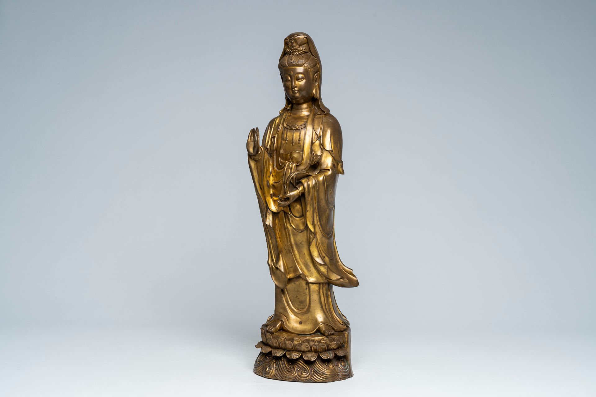 A large Chinese gilt copper sculpture of a standing Guanyin with ruyi sceptre on a lotus throne, Rep