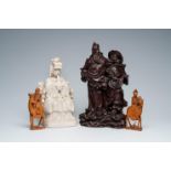 Four various Chinese wood and blanc de Chine figures, 19th/20th C.
