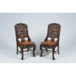 A pair of Chinese carved hardwood 'dragon' chairs, 19th C.