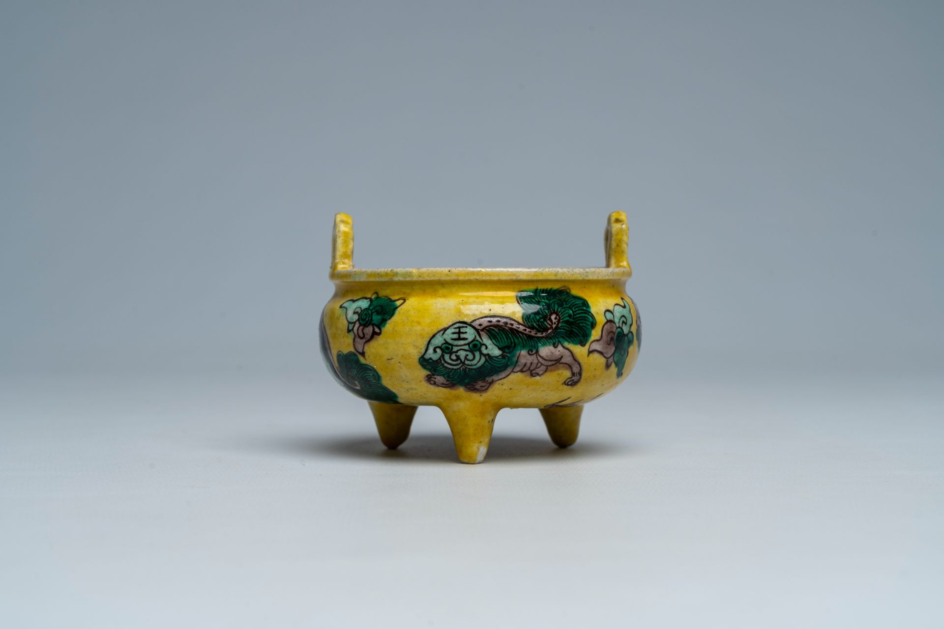 A Chinese verte biscuit yellow-ground 'Buddhist lions' tripod censer, 19th C. - Image 3 of 8