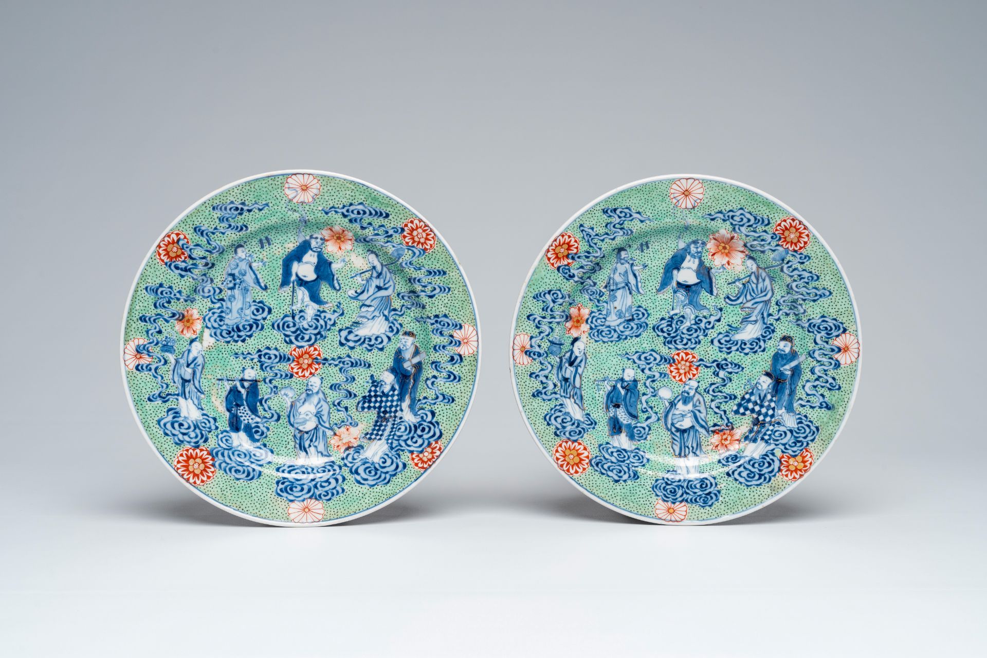 A pair of clobbered Chinese blue and white 'Eight Immortals' plates, Xuande mark, 19th C. - Image 2 of 3