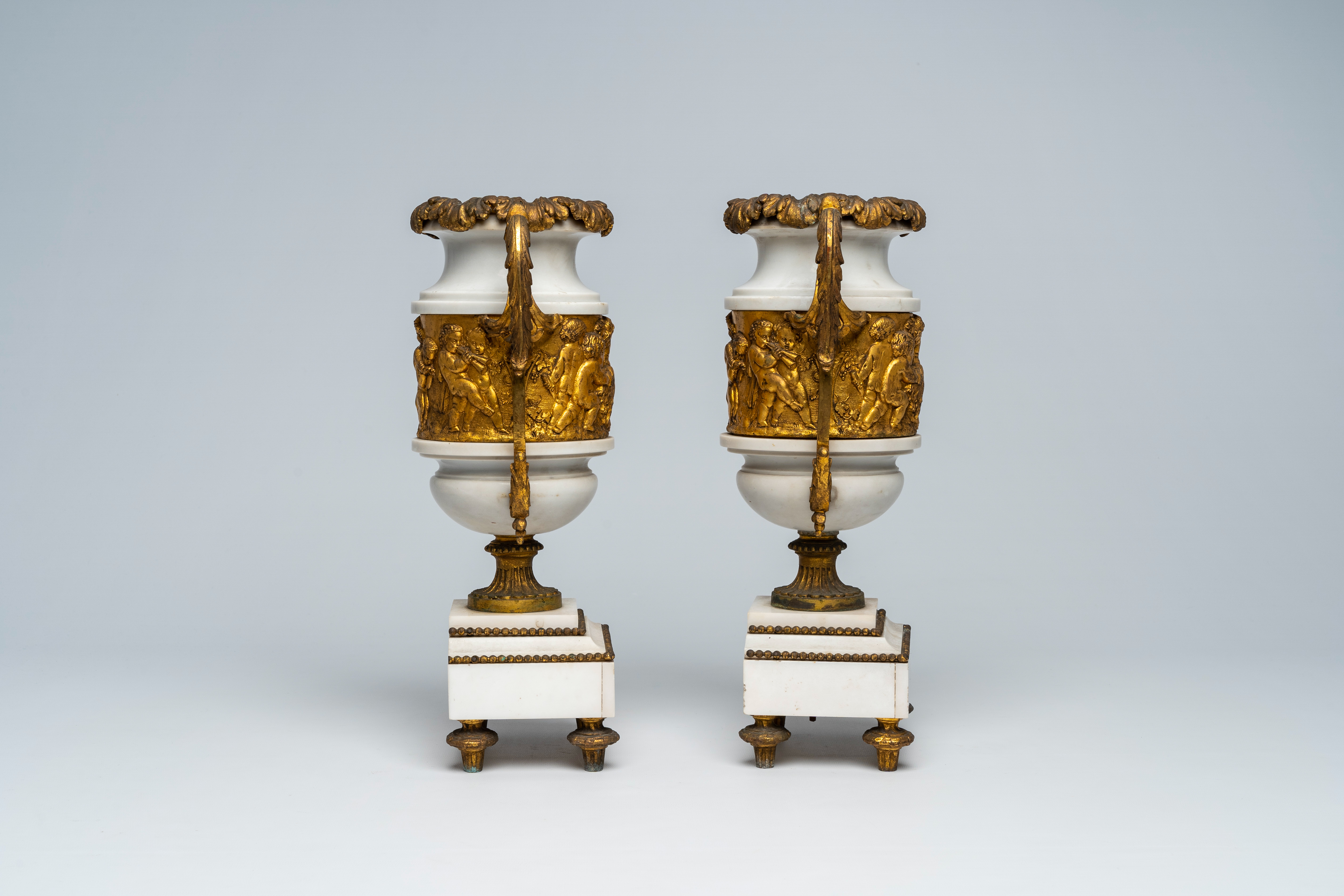 A pair of French gilt mounted white marble vases with relief design of putti, goats and Bacchus them - Image 4 of 7