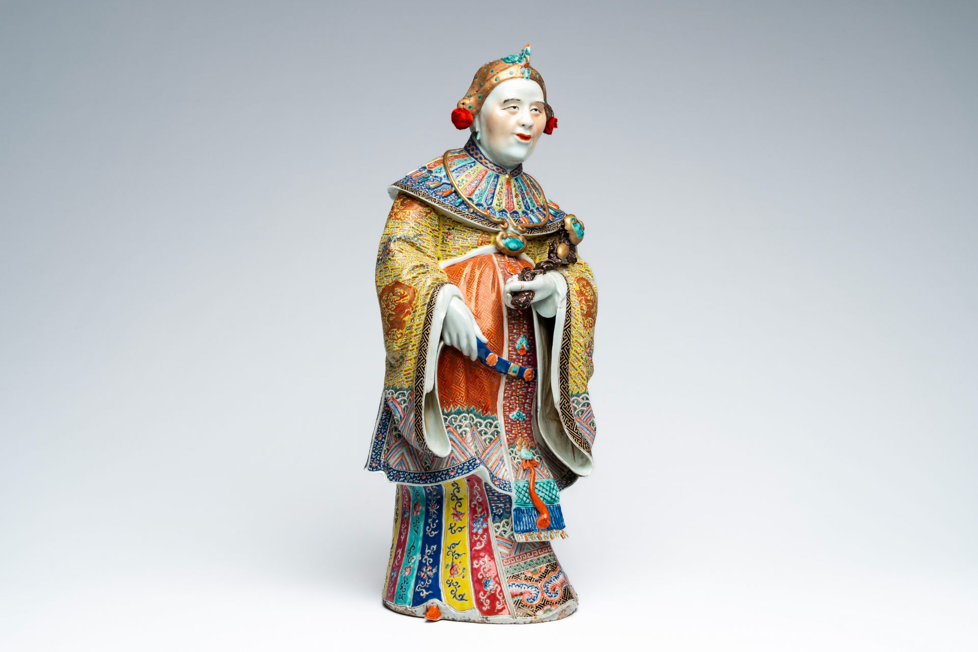 A Chinese famille rose figure of an elder holding a ruyi scepter, Republic, 20th C.