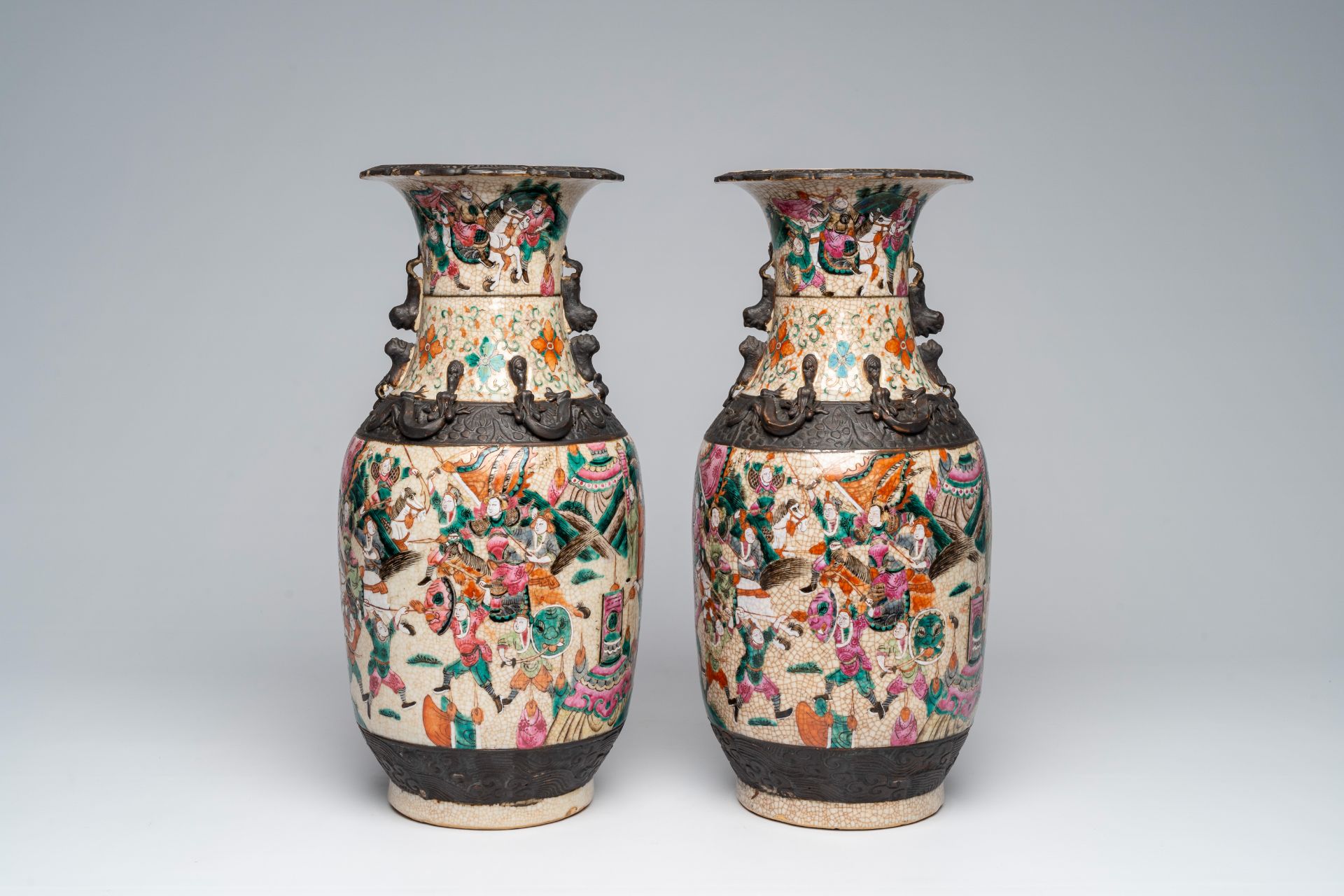 A pair of Chinese Nanking crackle glazed famille rose 'warrior' vases, 19th C. - Image 4 of 6
