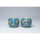 A pair of Chinese blue ground famille verte 'dragons chasing the pearl' ginger jars, 19th C.