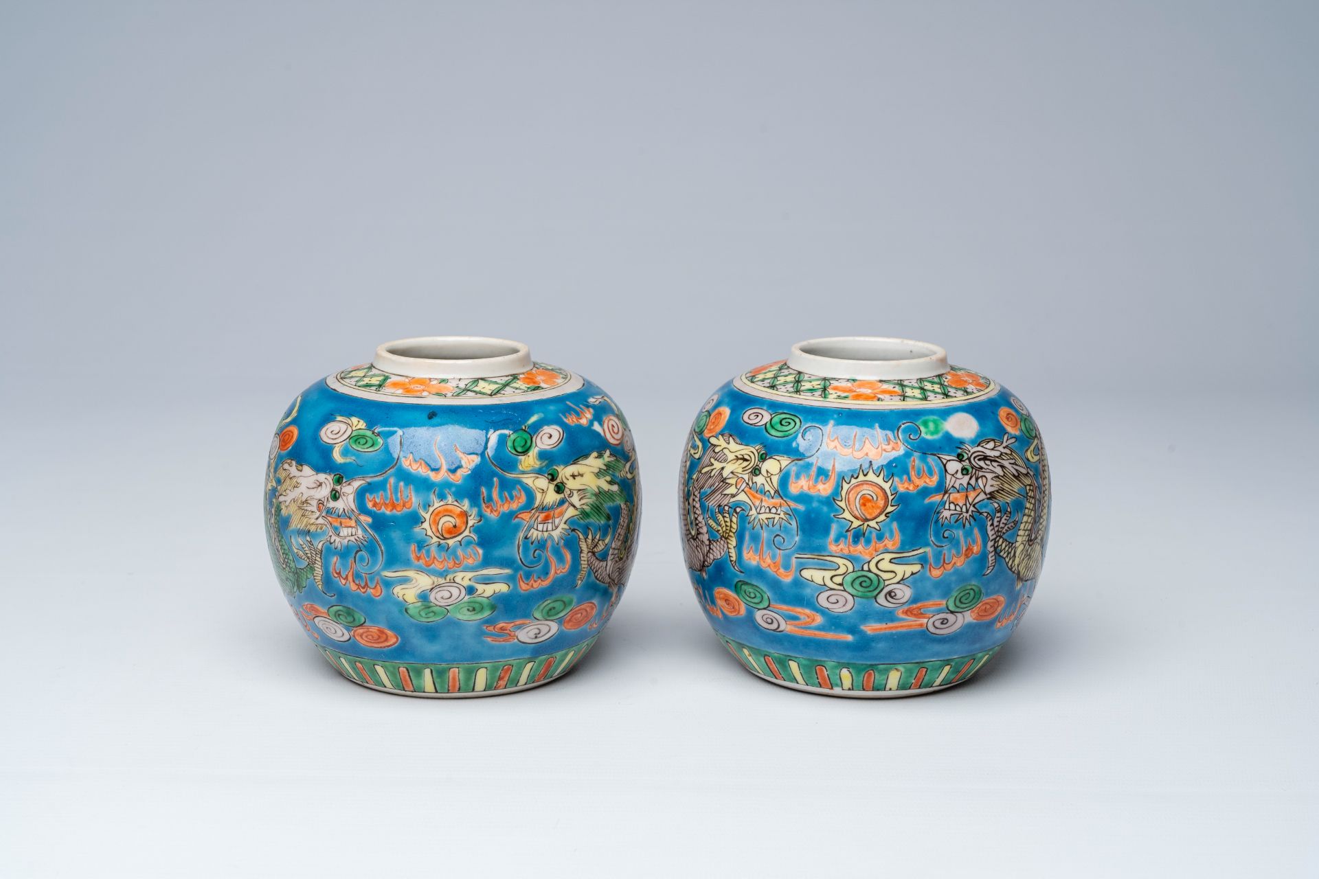 A pair of Chinese blue ground famille verte 'dragons chasing the pearl' ginger jars, 19th C.