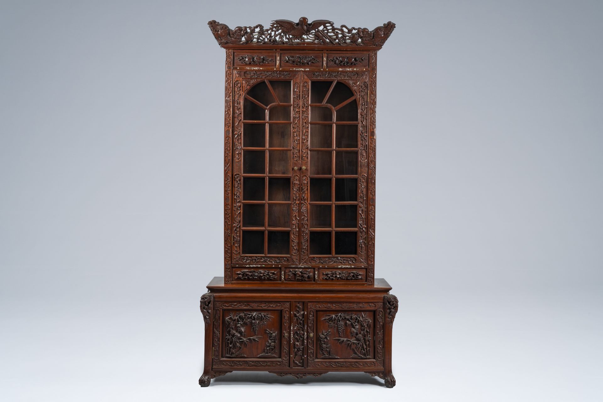 A Chinese or Vietnamese wooden four-door display cabinet with mother-of-pearl inlay, ca. 1900