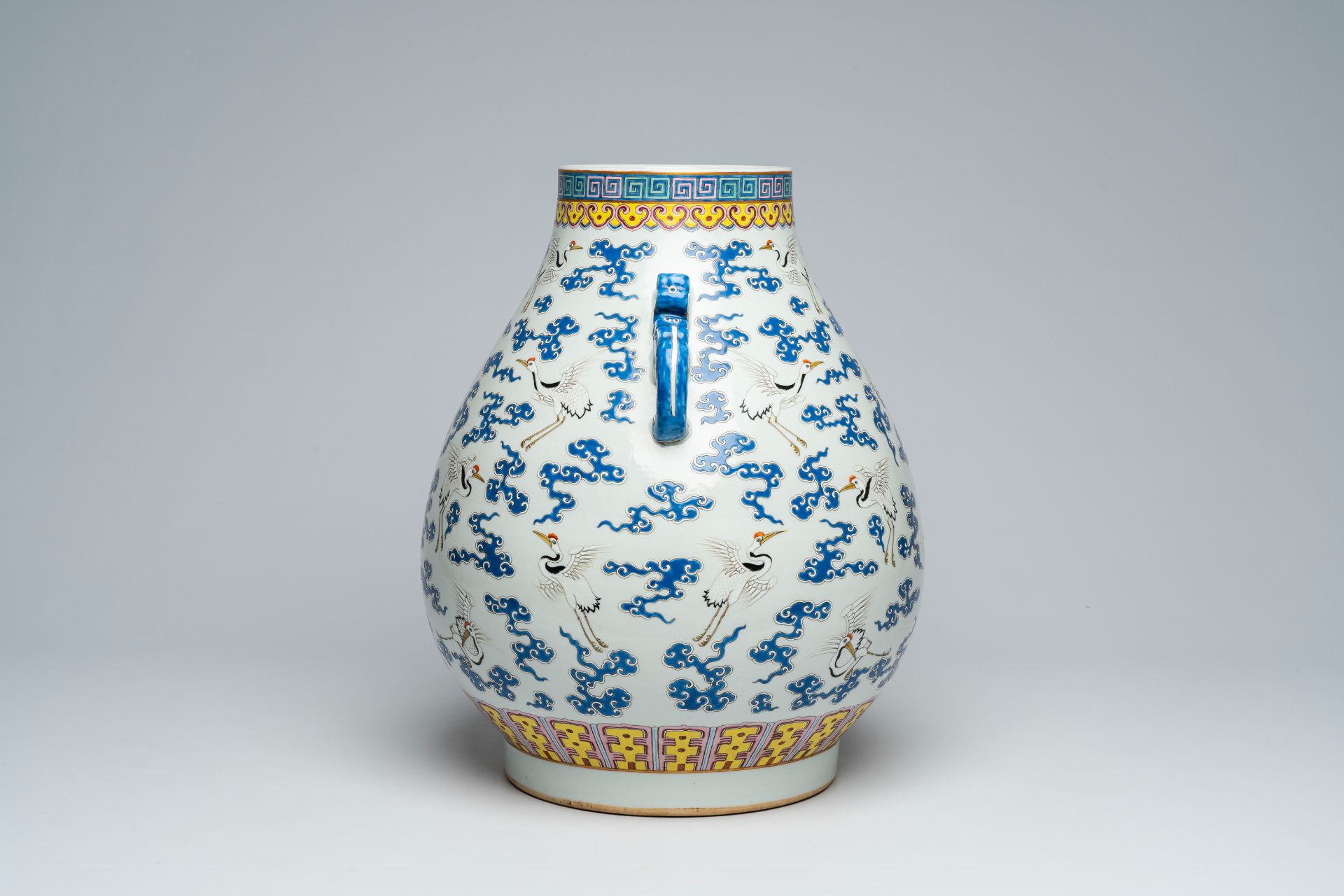 A Chinese famille rose 'hu' vase with cranes between clouds, Qianlong mark, 20th C. - Image 4 of 6