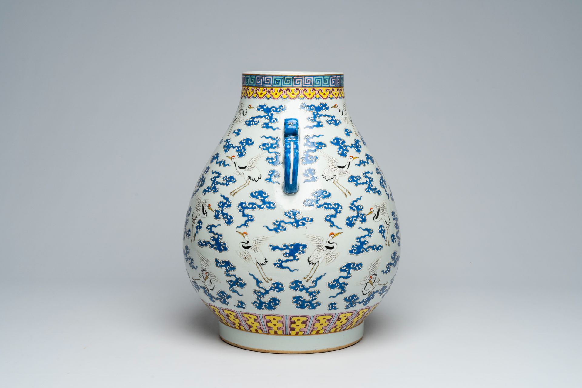 A Chinese famille rose 'hu' vase with cranes between clouds, Qianlong mark, 20th C. - Image 2 of 6