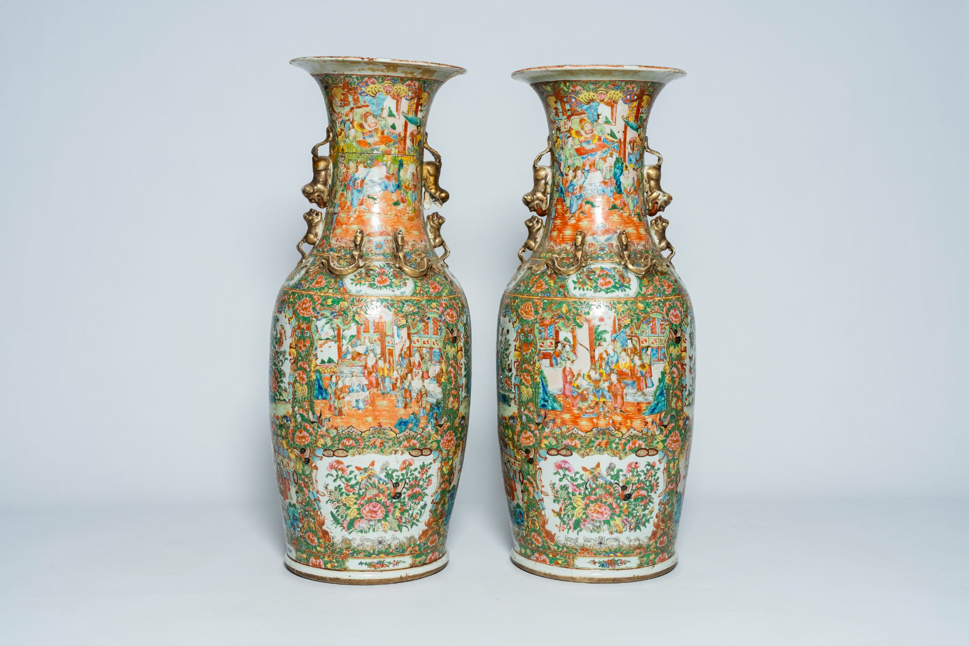 A pair of large Chinese Canton famille rose vases with palace scenes and floral design, 19th C.