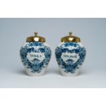 A pair of Dutch Delft blue and white tobacco jars with brass lids, 18th C.