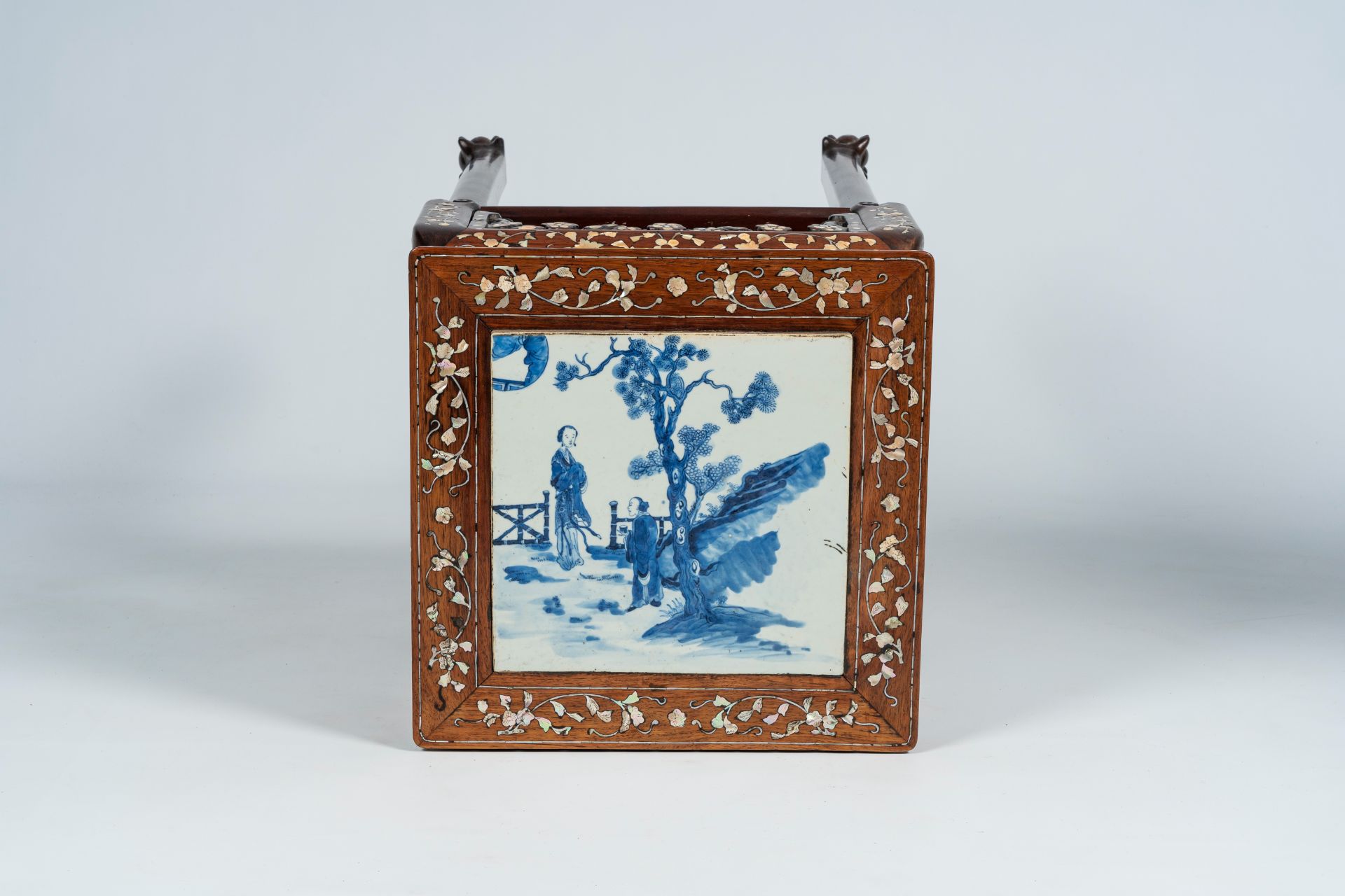 A Chinese mother-of-pearl-inlaid wooden stand with blue and white porcelain top, 19th C.