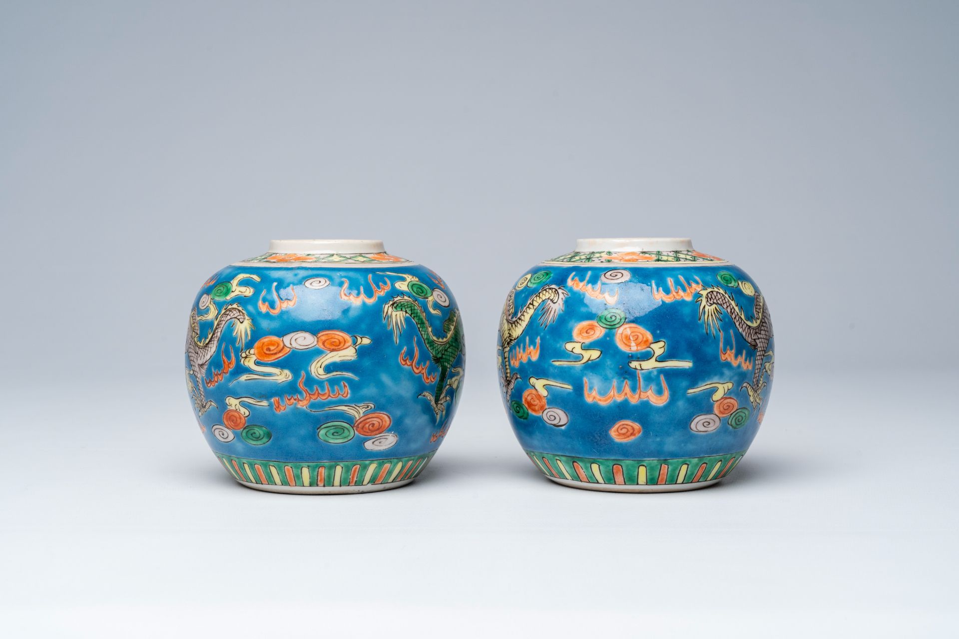 A pair of Chinese blue ground famille verte 'dragons chasing the pearl' ginger jars, 19th C. - Image 4 of 7