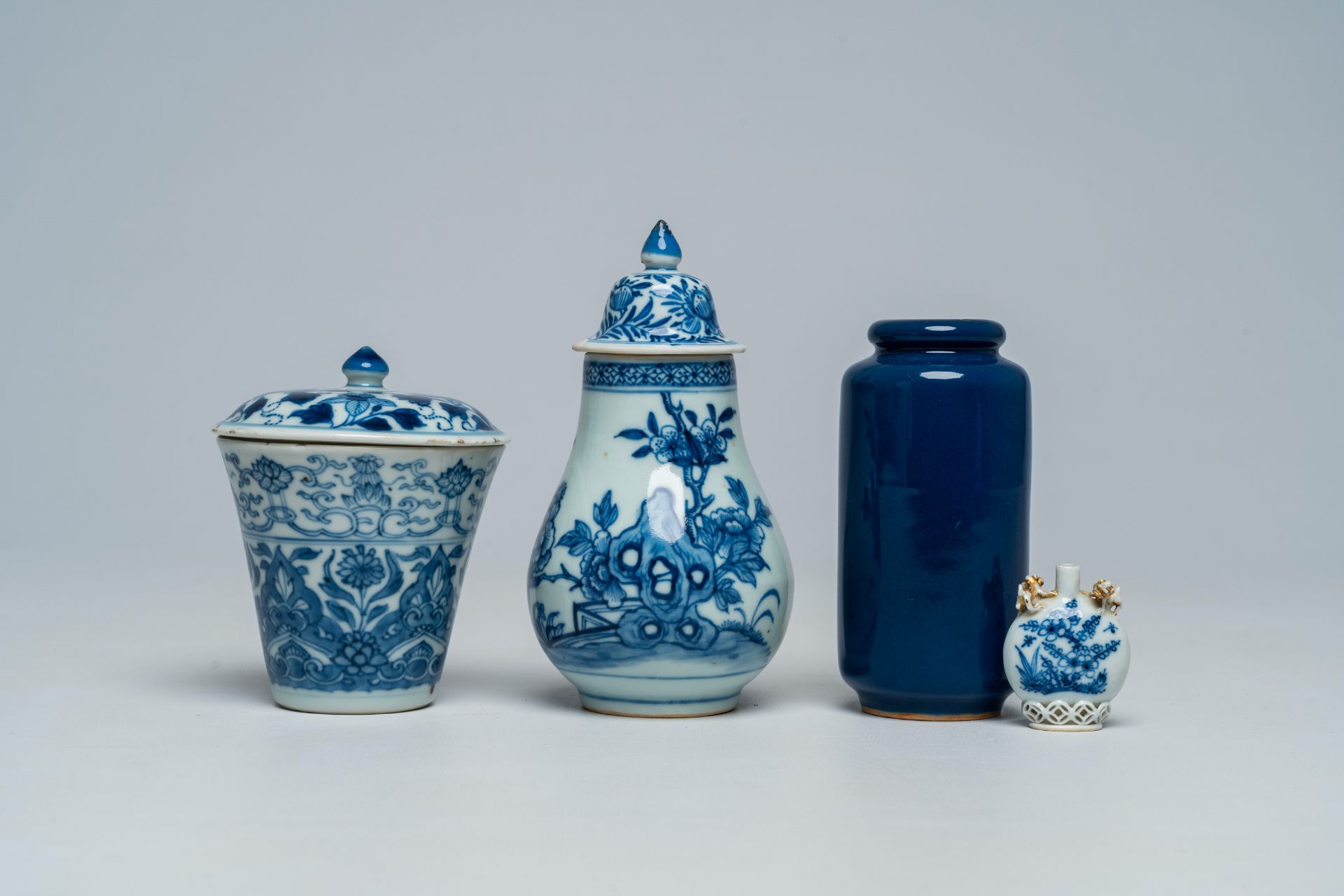 A Chinese blue and white snuff bottle, two covered beakers and a small blue rouleau vase, Kangxi and
