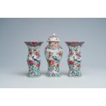 A Chinese famille rose three-piece vase garniture with a bird among blossoming branches, Yongzheng/Q