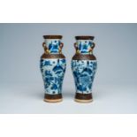 A pair of Chinese Nanking crackle glazed blue and white vases with birds and butterflies among bloss