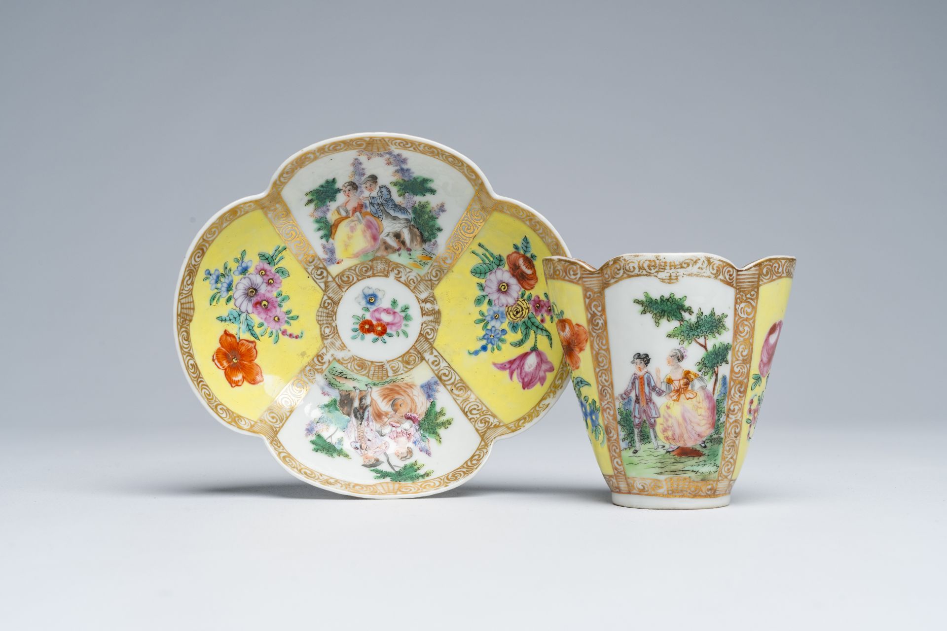 A Chinese famille rose Meissen style quatrefoil beaker and saucer with galant scenes, Augustus Rex m