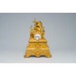 A French gilt bronze mantel clock topped with an angel, 19th C.