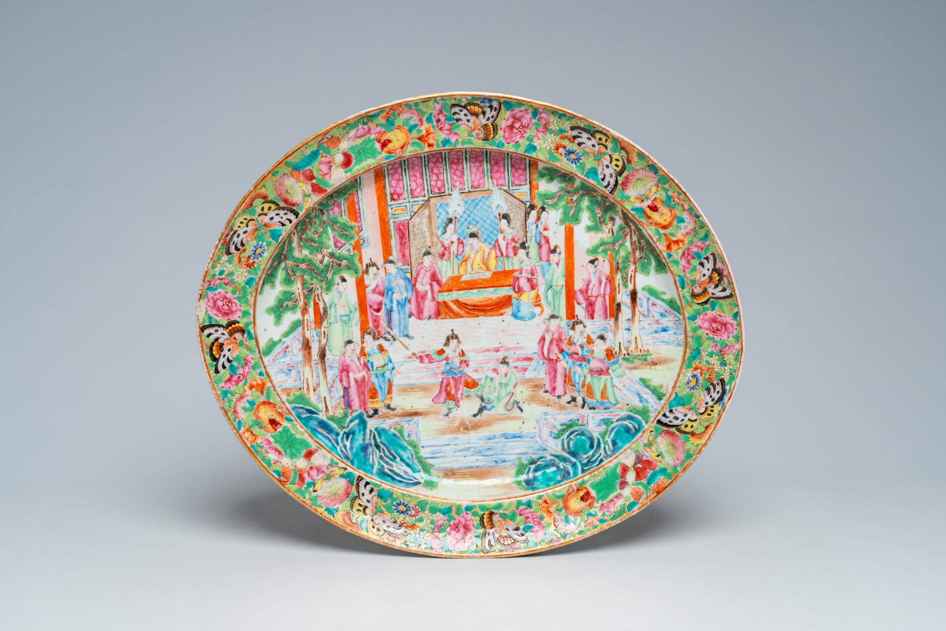 An oval Chinese Canton famille rose charger with a palace scene, 19th C.