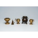 A varied collection of bronze and brass items, a.o. a pair of candlesticks and a mortar, 17th C. and