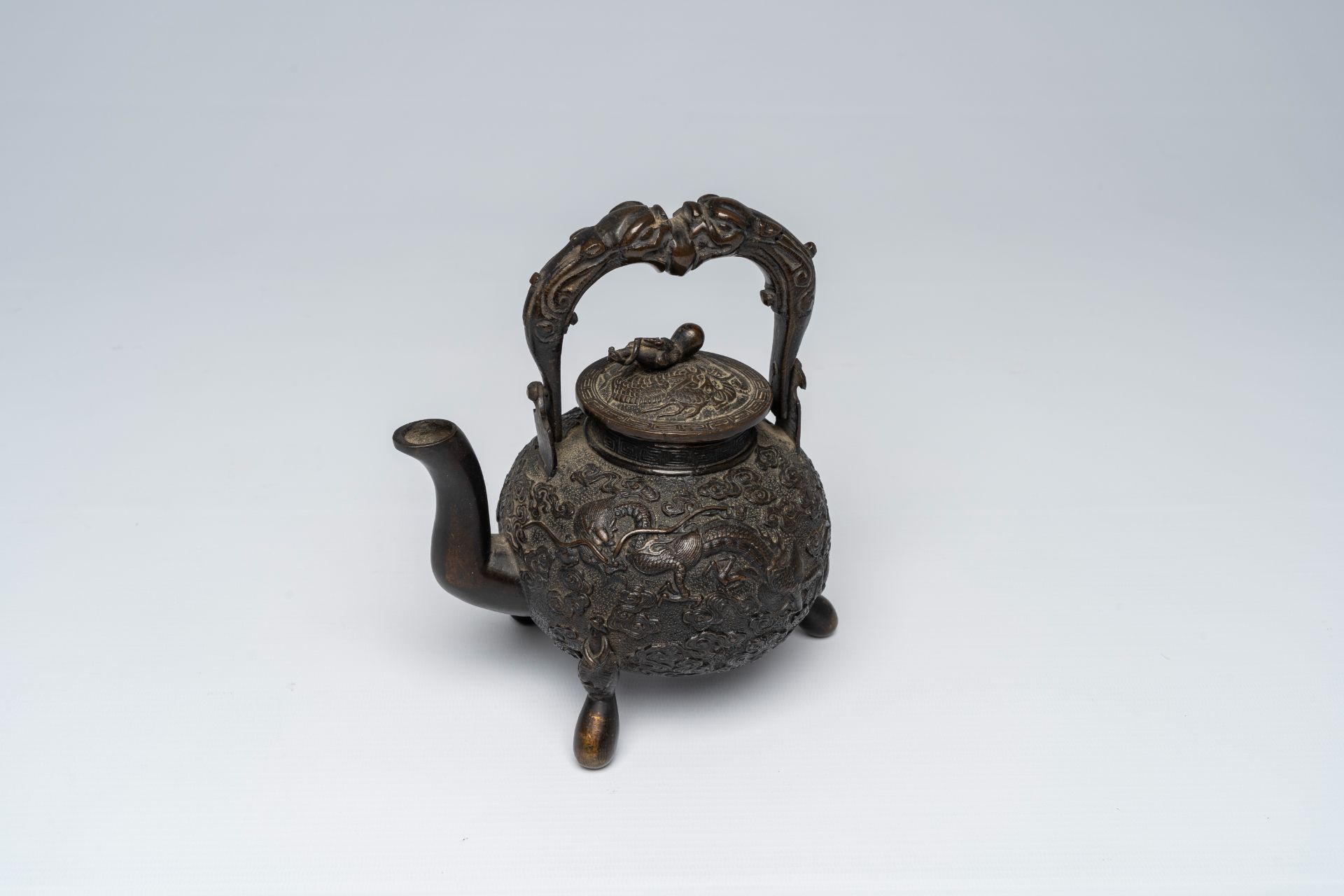 A Chinese tripod bronze teapot and cover with dragon relief design and double gourds, ca. 1900 - Image 2 of 8