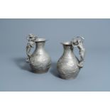 Charles ThÃ©odore Perron (1862-1934): A pair of Art Nouveau pewter 'nymphs and cherubs' pitchers wit