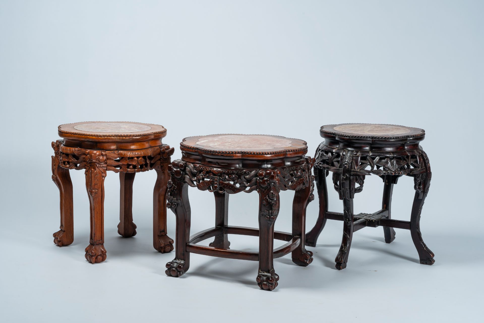 Three Chinese open worked lobed carved wood stands with marble top, 19th/20th C.