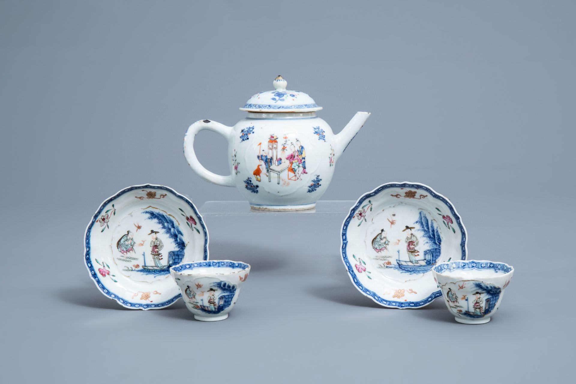 A Chinese famille rose teapot and a pair of cups and saucers, Qianlong