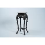 A Chinese reticulated carved wood stand with marble top, 19/20th C.