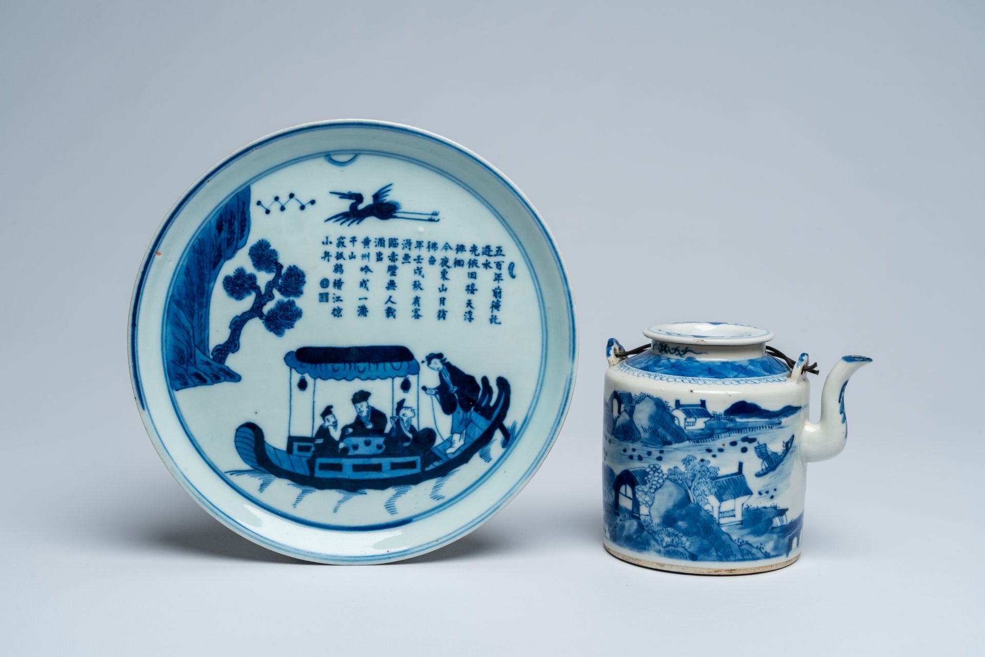 A Chinese blue and white Vietnamese market 'Bleu de Hue' teapot and cover and an 'Immortals' dish, 1