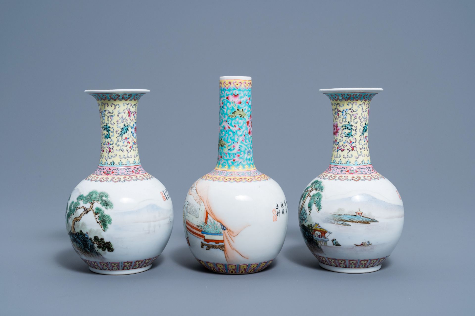 A pair of Chinese bottle shaped famille rose vases with an animated landscape and a vase with figura - Image 2 of 5