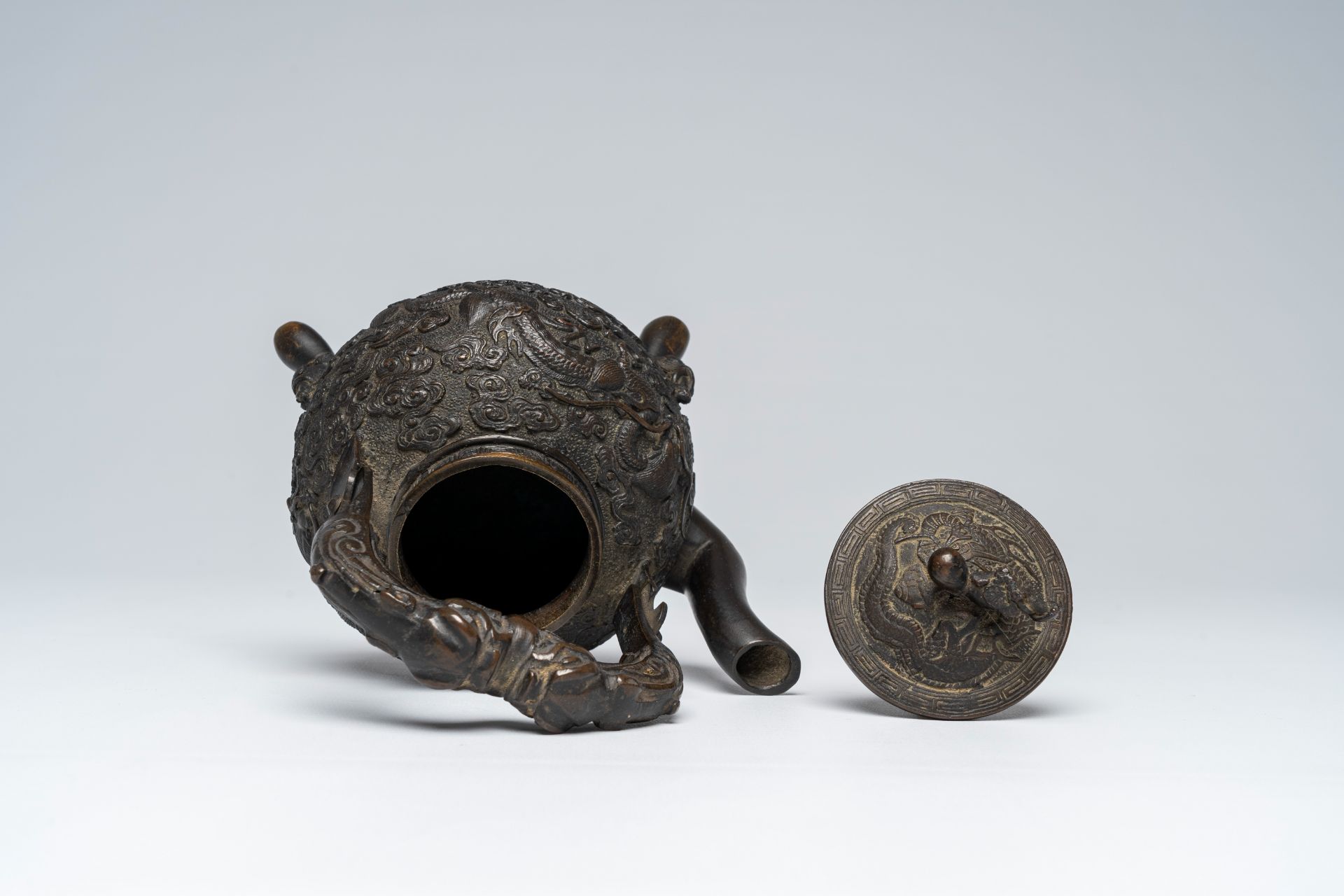 A Chinese tripod bronze teapot and cover with dragon relief design and double gourds, ca. 1900 - Image 7 of 8