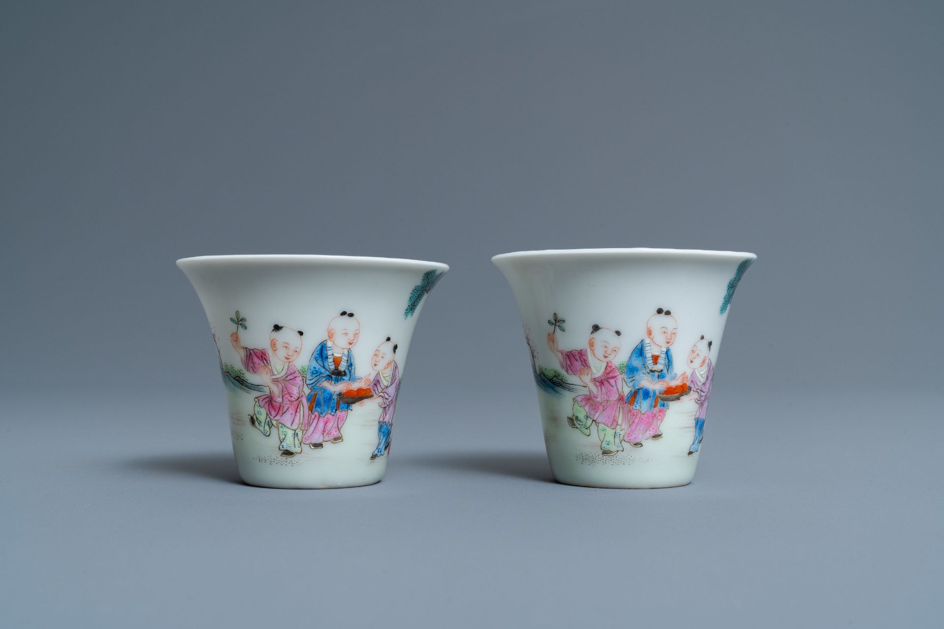 A pair of Chinese famille rose 'playing boys' wine cups, Qianlong mark, Republic, 20th C. - Image 2 of 7