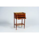 A French mahogany gilt brass mounted side table with three drawers, late 19th C.