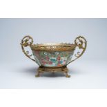 A Chinese Canton famille rose brass mounted bowl with palace scenes and floral design, 19th C.